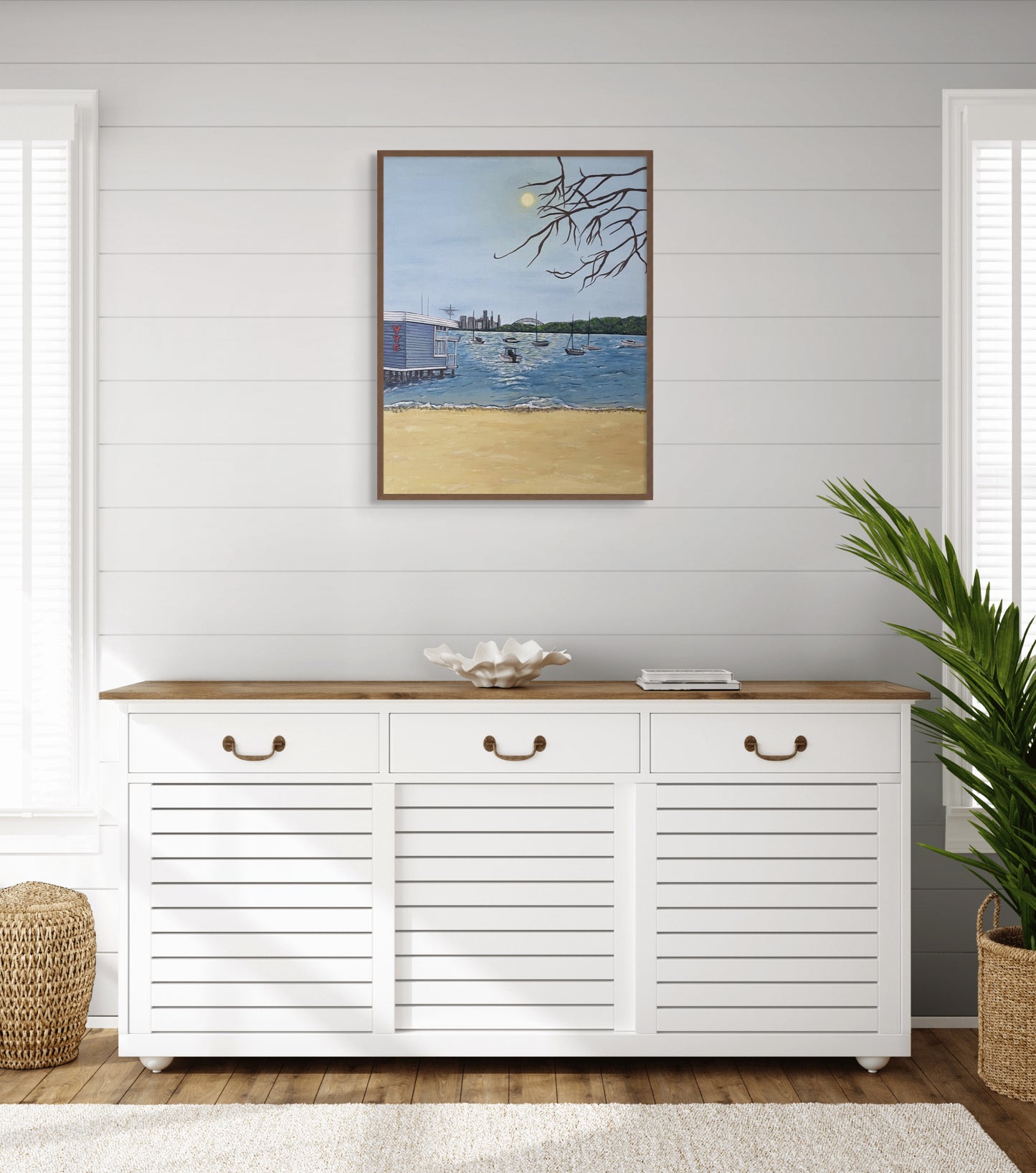 Framed painting of the Watson's Bay harbour hangs in an aesthetic beach house