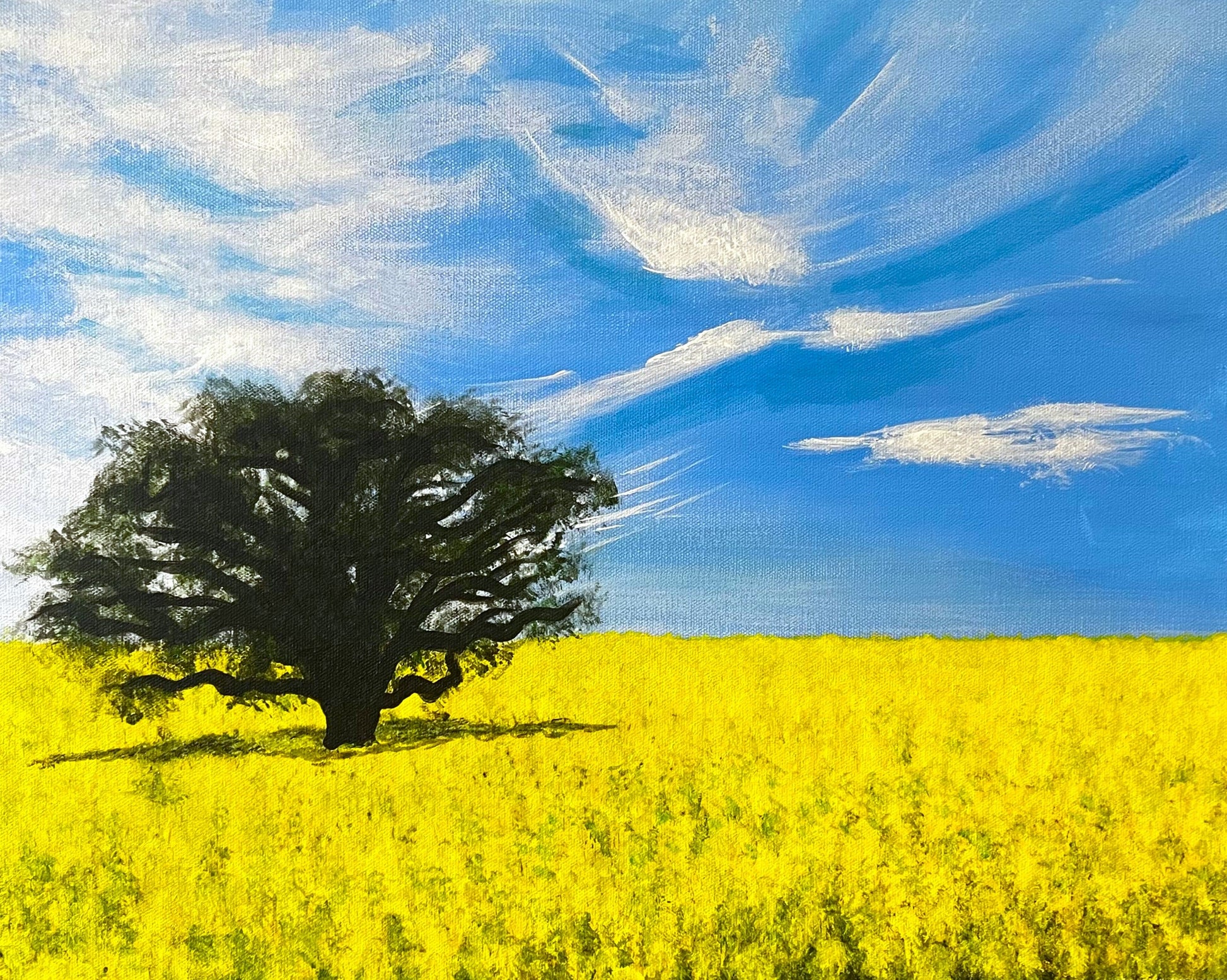 Painting on canvas of a canola field and lone tree, under a blue sky and wispy clouds