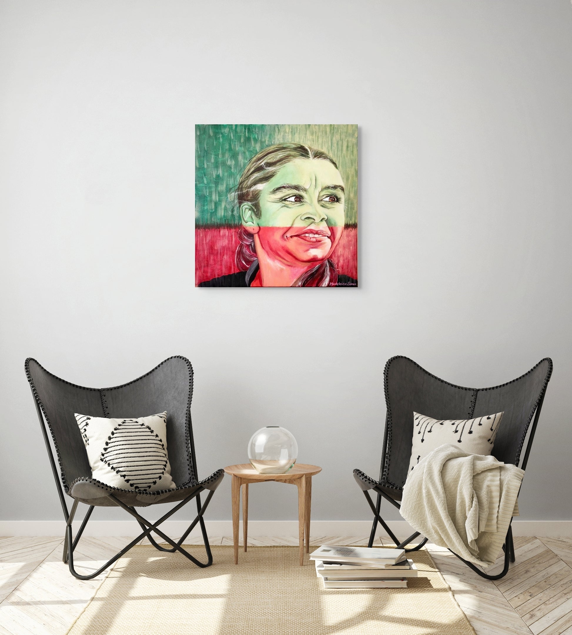 Green and red portrait of an Aboriginal woman hanging above a reading nook.