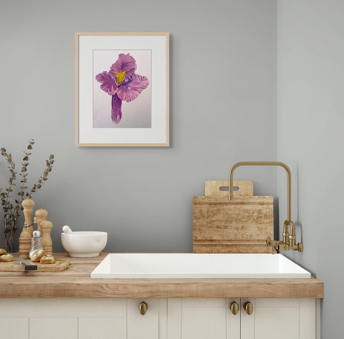 Framed painting of a raspberry-coloured iris flower hangs above a modern farmhouse style kitchen sink.