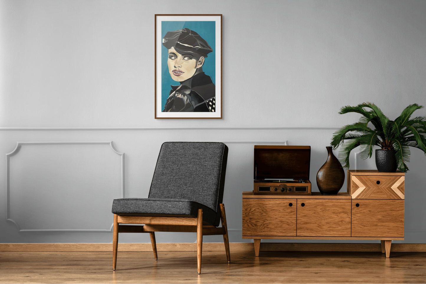 Portrait painting of a woman in a leather cap and jacket hangs above a retro vinyl record player. 