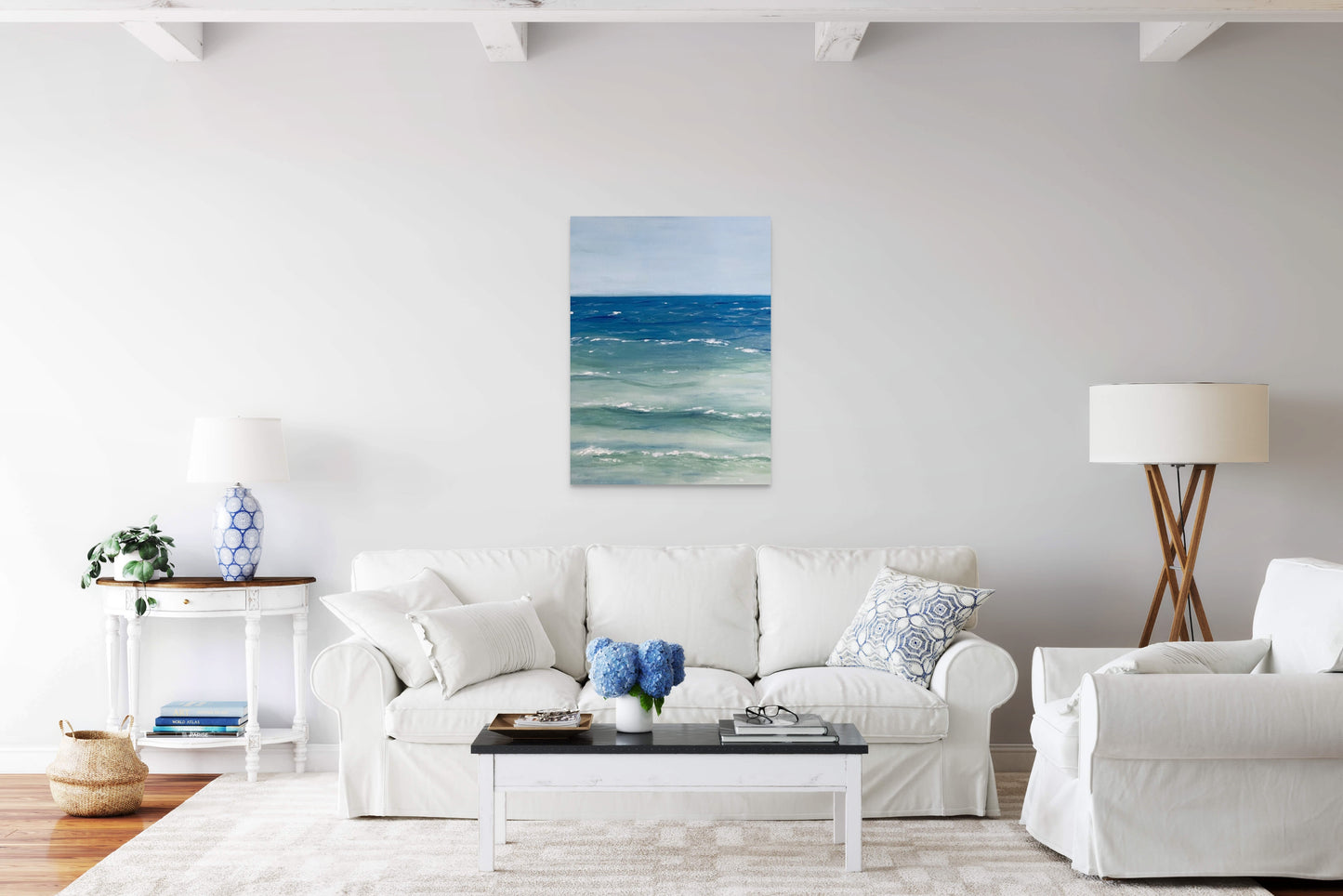 Painting of the sea hangs in a modern beach house lounge.