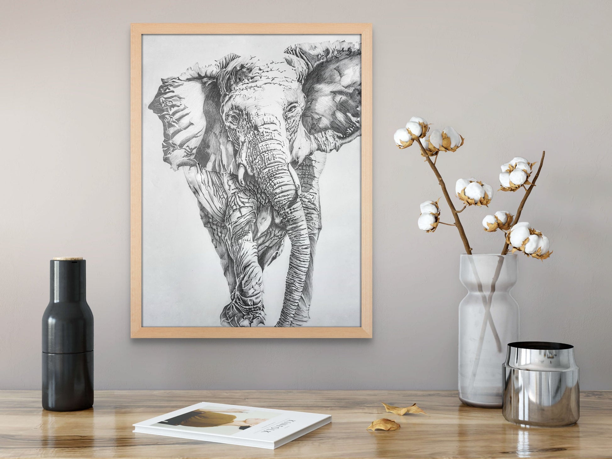 Pencil drawing of an elephant hanging above a vase of cotton on a table.