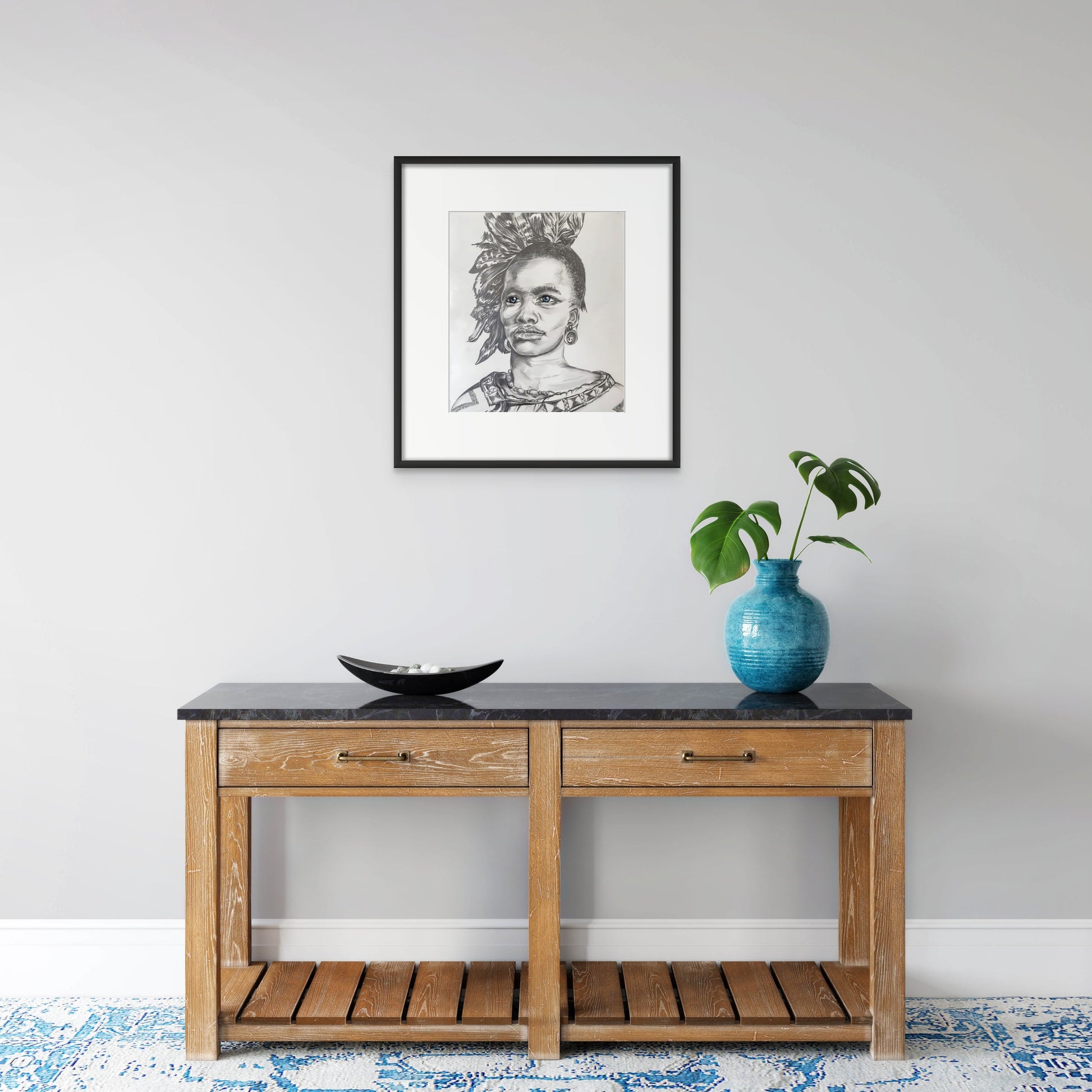 Portrait in pencil of an African tribal Chief wearing a feathered headdress hanging in an entrance hall.